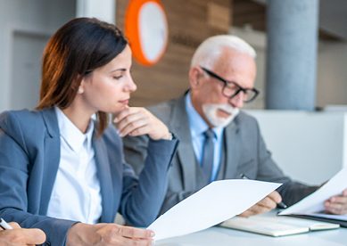 Business people reading documents during a corporate meeting
